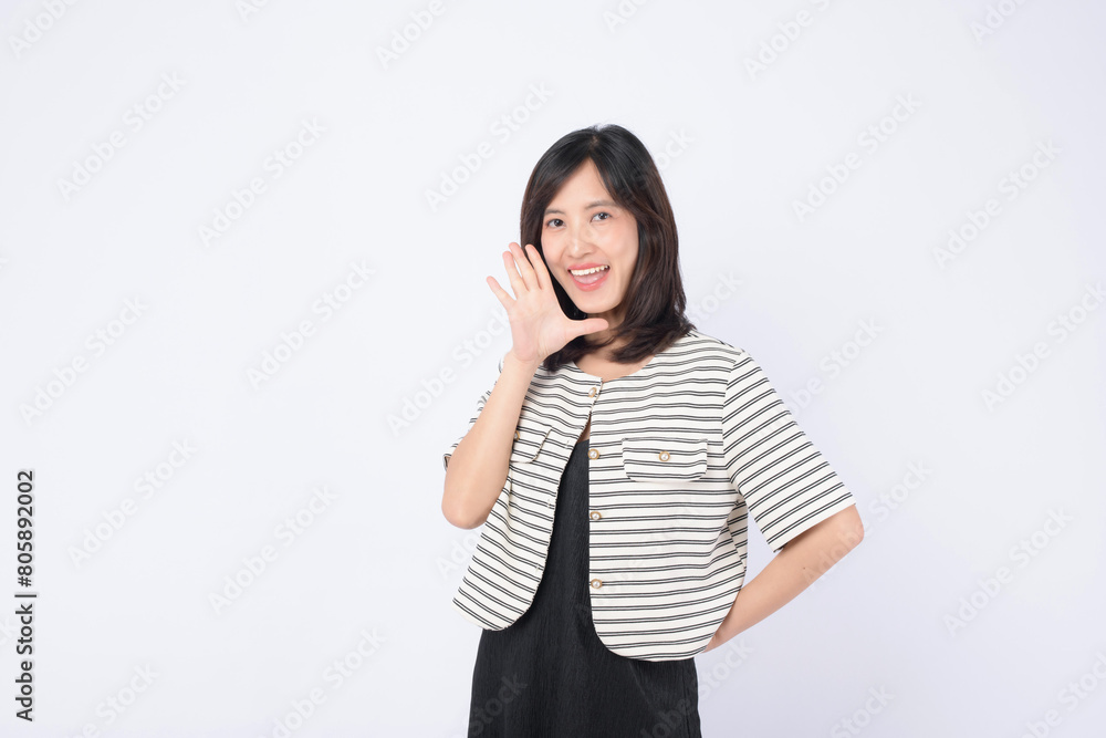 Asian woman is posing with a shouting gesture against a white background. Asian woman is posing with a shouting gesture against a white background.