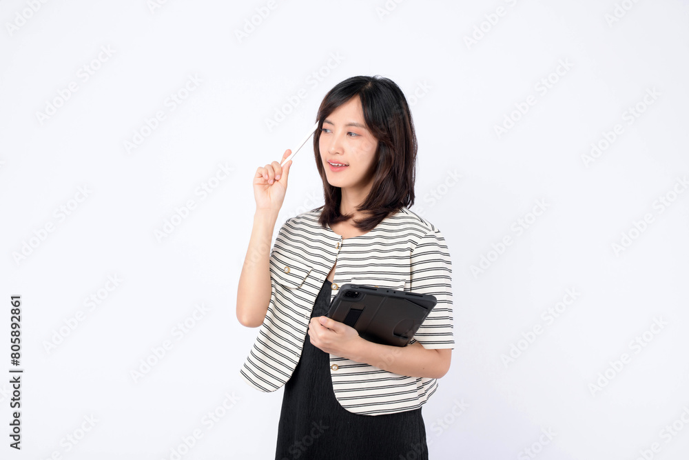Asian woman is thinking or planning while using a tablet against a white background. Asian woman is thinking or planning while using a tablet against a white background.