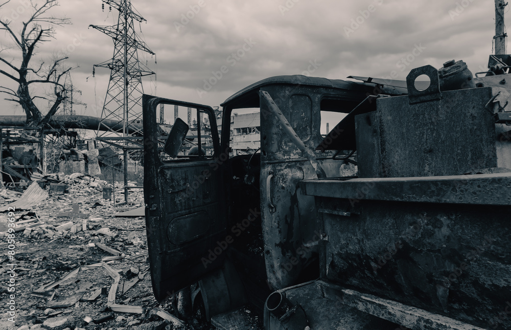 Fototapeta premium burnt cars and destroyed buildings of the workshop of the Azovstal plant in Mariupol