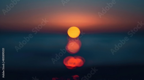 Out of focus sun setting over the ocean glowing orange with dark blue background Abstract bokeh blured background  defocused space for your text  blurred pattern concept design  bokeh background