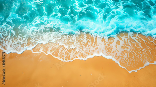 The ocean is calm and the waves are small. The water is blue and the sand is yellow. Beach with golden sand and waves at seashore. Blue ocean and golden sand.