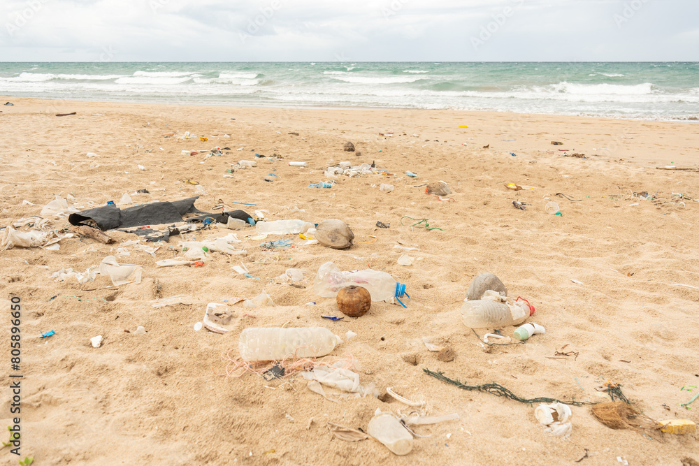 Obraz premium Sri Lanka, Bottles of plastic and garbage on the sand on the beach near the ocean, sea pollution catastrophe.