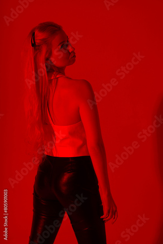 Beautiful blonde woman from back through red filter photo