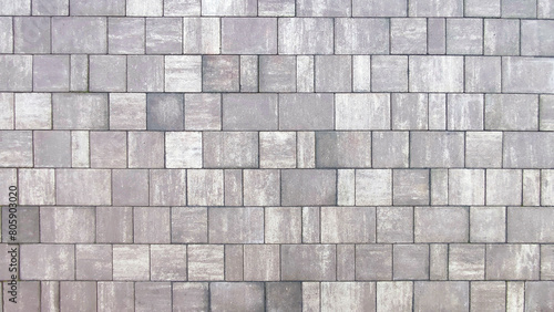 Grey brick wall background close up. Gray stone tile block backgroun
