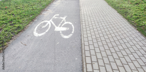 empty bicycle path with markings in a city park. bicycle sign on the bike path