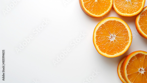Sliced fresh oranges arranged neatly on a clean white background, showcasing vibrant orange hues and juicy texture.