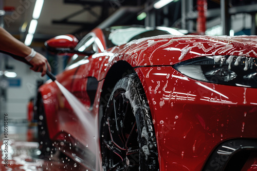 Car Wash Pressure Wash  with Foam to Rinse a Red Modern Sportscar. © Ekaterina Shvaygert