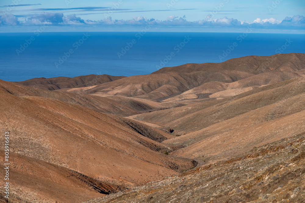 Panoramic view on colourful remote basal hills and mountains of Massif of Betancuria as seen from observation point, Fuerteventura, Canary islands, Spain