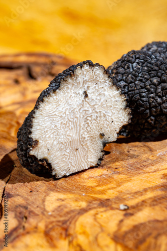 Cooking with Italian black summer truffle, tasty aromatic mushroom, close up