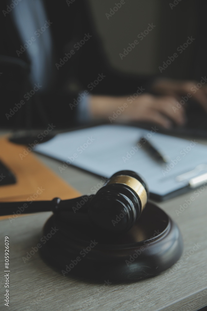 Business and lawyers discussing contract papers with brass scale on desk in office. Law, legal services, advice, justice and law concept picture with film grain effect Business and lawyers discussing contract papers with brass scale on desk in office. Law, legal services, advice, justice and law concept picture with film grain effect