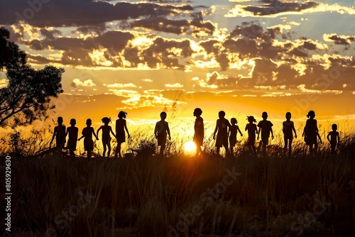 Dramatic silhouette of a group walking through the Australian outback at sunset, capturing the essence of adventure and the spirit of the land.  © Karen