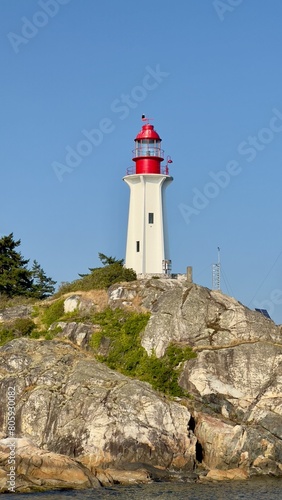 Lighthouse on rocks with Royal Eagle on top in Vancouver Canada © Arnaud