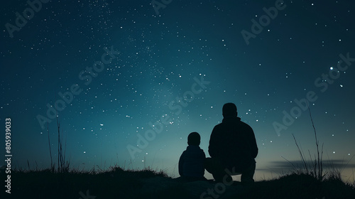 Silhouettes of a father and child stargazing 
