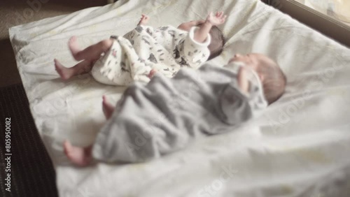 Twin male and female babe crying while moving their arms and legs (1)