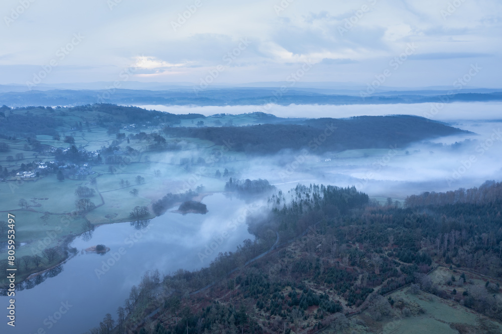 Stunning drone aerial landscape image of cloud inversion around Esthwaite Water in Lake District during Spring sunrise Stunning drone aerial landscape image of cloud inversion around Esthwaite Water in Lake District during Spring sunrise