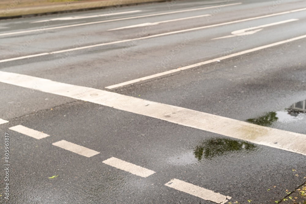 directional arrows on a wet asphalt road