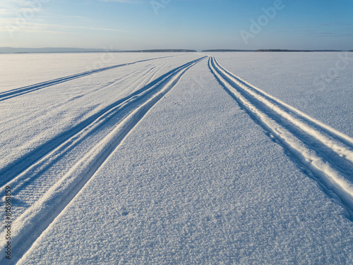 Snowmobile tracks on a snow covered frozen lake in Finland