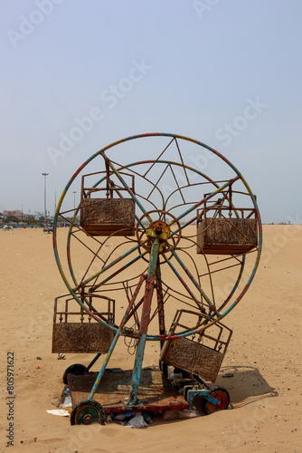 Vintage Ferris Wheel Standing Alone on a Sandy Beach