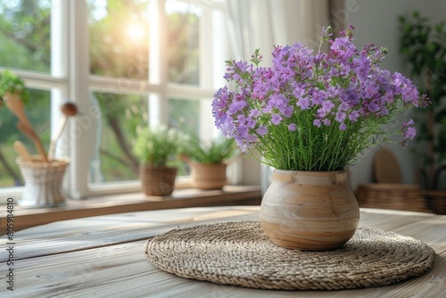 Vase with purple flowers on wooden table in room