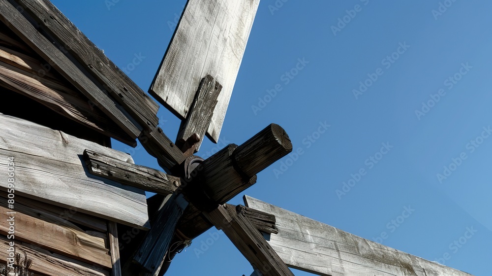 Windmill on farm, blade detail close-up, old wood texture, clear blue sky Windmill on farm, blade detail close-up, old wood texture, clear blue sky