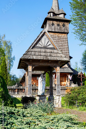 DZIANISZ, POLAND - MAY 04, 2024: Historic wooden church and its surroundings in Dzianisz, Poland.