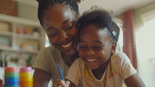 African American mother and young adorable daughter having fun laughing and drawing using colorful crayon pencils at home, Mother's Day lifestyle activity bonding relationship children with parents