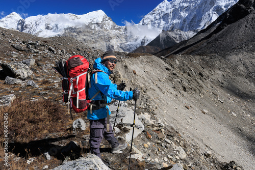 Sherpa mountain guide on his way to the camp Chukhung after crossing the Amphu Labtsa (aka Amphu Laptsa or Amphu Lapcha) pass (5,845m)  in the Imja valley, Khumbu region, Himalaya, Nepal photo