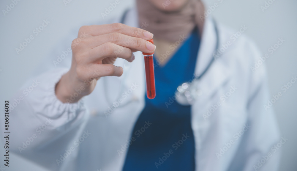 Technician, doctor, scientist in laboratory with blood sample tubes and rack In the laboratory holding a blood vessel sample for study, experiment, medical research biotechnology DNA testing. Technician, doctor, scientist in laboratory with blood sample tubes and rack In the laboratory holding a blood vessel sample for study, experiment, medical research biotechnology DNA testing.
