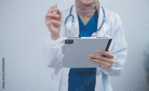 Wallpaper Mural Doctor wearing white coat and watching patient data in Tablet . Torontodigital.ca