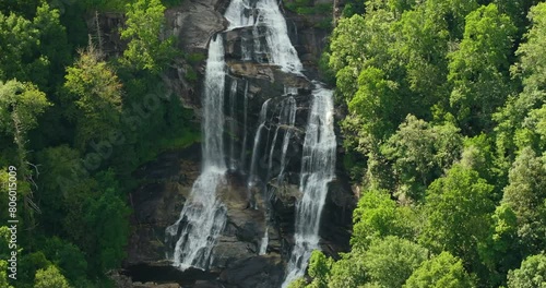 Aerial view of Whitewater Falls in Nantahala National Forest, North Carolina, USA. Clear water falling down from rocky boulders between green lush woods photo