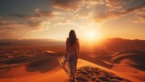 Sexy woman walking in the desert.Beautiful view on the mountain at sunset. Amazing sand dunes. Golden sand waves. Natural safari panorama. Unique journey.