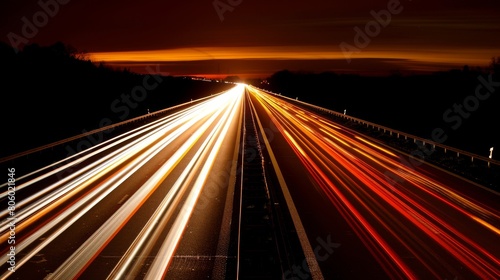 Nighttime long exposure of a road. A vibrant long exposure shot capturing the dynamic lights of cars traversing a road at night, reflecting the urban pulse