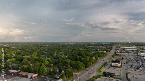 Flying towards tree cover of Lexington, Kentucky neighborhoods over Nicholasville road and Fayette mall parking lots. photo