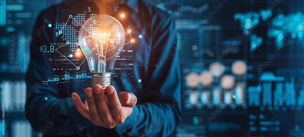 © Chand Abdurrafy - Businessman holding a light bulb with a digital graph and financial icon on a virtual screen, showing a concept of business growth for data technology and online marketing © Chand Abdurrafy - Businessman holding a light bulb with a digital graph and financial icon on a virtual screen, showing a concept of business growth for data technology and online marketing