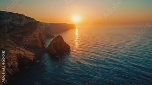 Coastal cliff against setting sun © 2D_Jungle