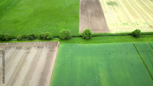 Luftbild einer Landschaft mit vielen Feldern durchzogen von ein schmales Gewässer mit wenigen Bäumen, Biodiversität in der Landwirtschaft, Kulturlandschaft  photo