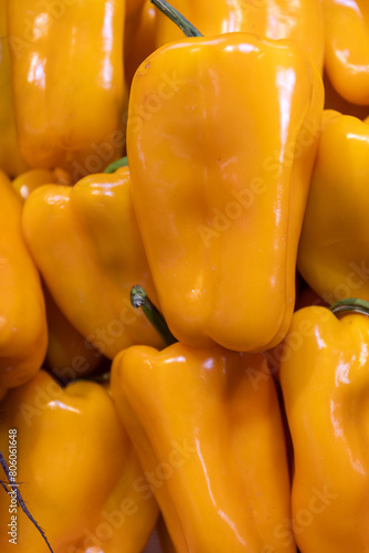 Close up shot of beautiful, healthy orange organic peppers in a wooden box. fresh fruit market, grower's market produce.