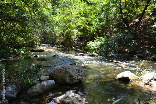 a stream with a large rocky stones in the middle of it 