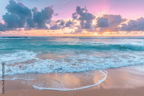 Pastel sunset reflecting on gentle waves at tranquil beach