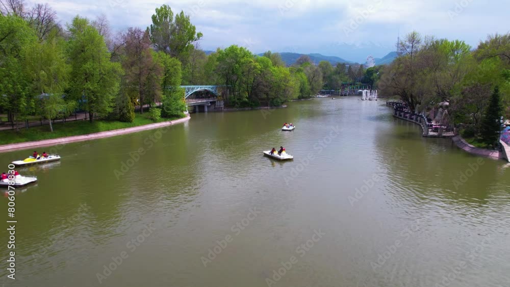 Boats and catamarans floating in the city park in the lake, drone view Boats and catamarans floating in the city park in the lake, drone view
