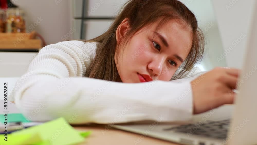 Tired exhausted, fatigue and fell asleep. Yaoung asian thai female working on laptop in kitchen room at home. Overwork. Exhausted woman sleeply eye at workplace Tired exhausted, fatigue and fell asleep. Yaoung asian thai female working on laptop in kitchen room at home. Overwork. Exhausted woman sleeply eye at workplace
