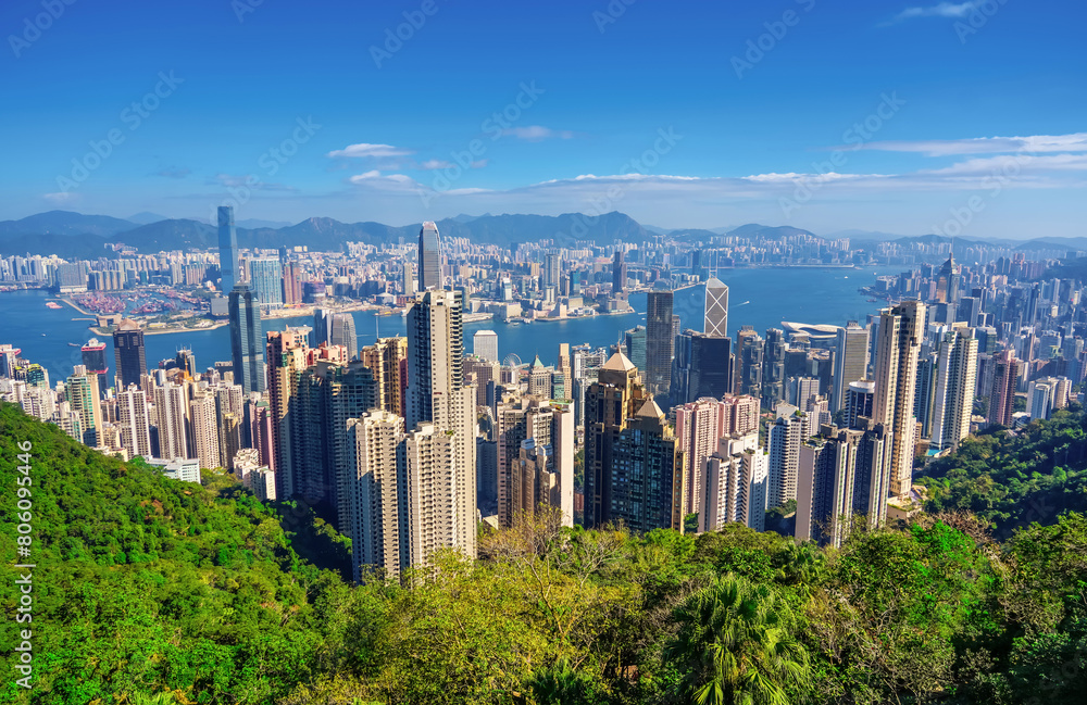 Fototapeta premium Wonderful panoramic of Hong Kong city view from Victoria Peak, modern cityscape during sunny day in the with amazing summer light clouds.