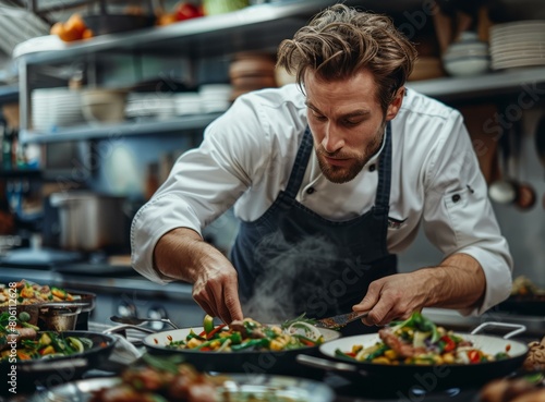 Focused male chef cooking in a commercial kitchen