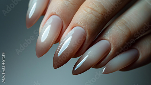 A sleek and polished manicure in a muted tone  reflecting the confidence and professionalism of a modern businesswoman.