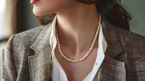 A timeless pearl necklace paired with a tailored blazer, epitomizing the sophistication and confidence of a businesswoman.