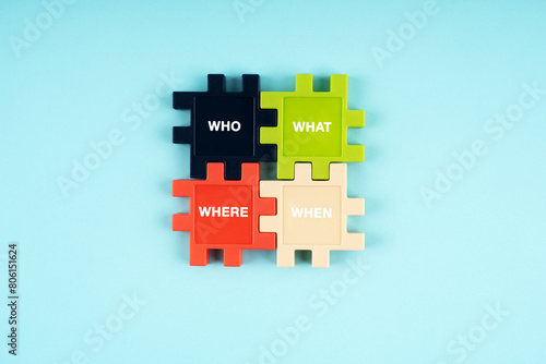 Who, what, where and when text on jigsaw puzzle pieces on blue background