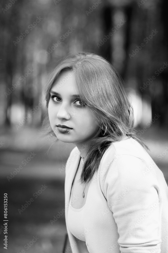 Portrait of a young beautiful red-haired girl outdoors. Black and white photo. Portrait of a young beautiful red-haired girl outdoors. Black and white photo.