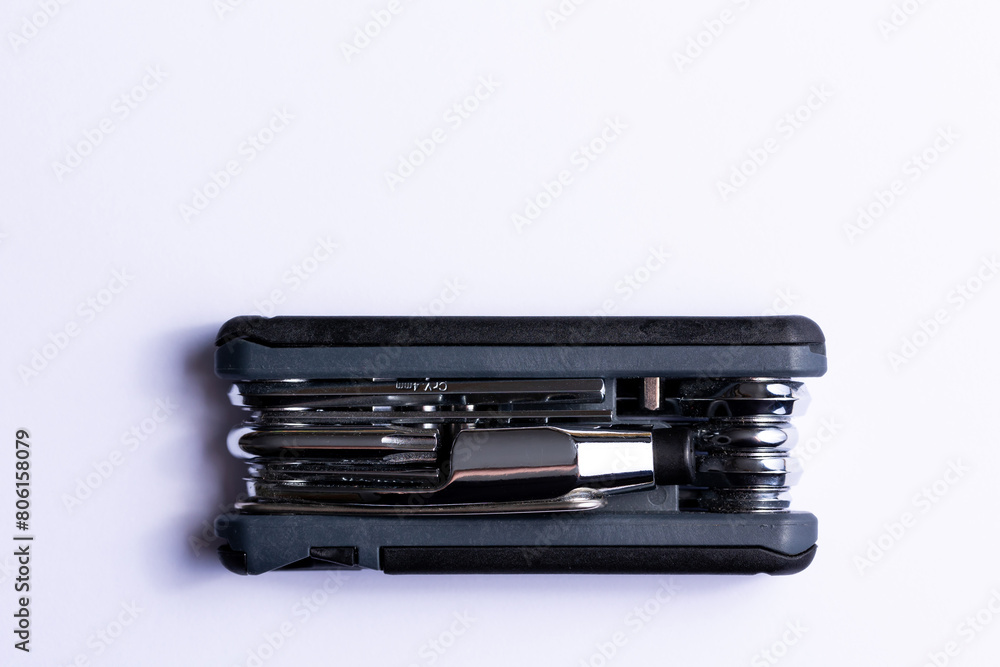 Black bicycle multifunctional multitool unfolded on a white background. Chrome steel tools. Tools for bicycle self-repairing .