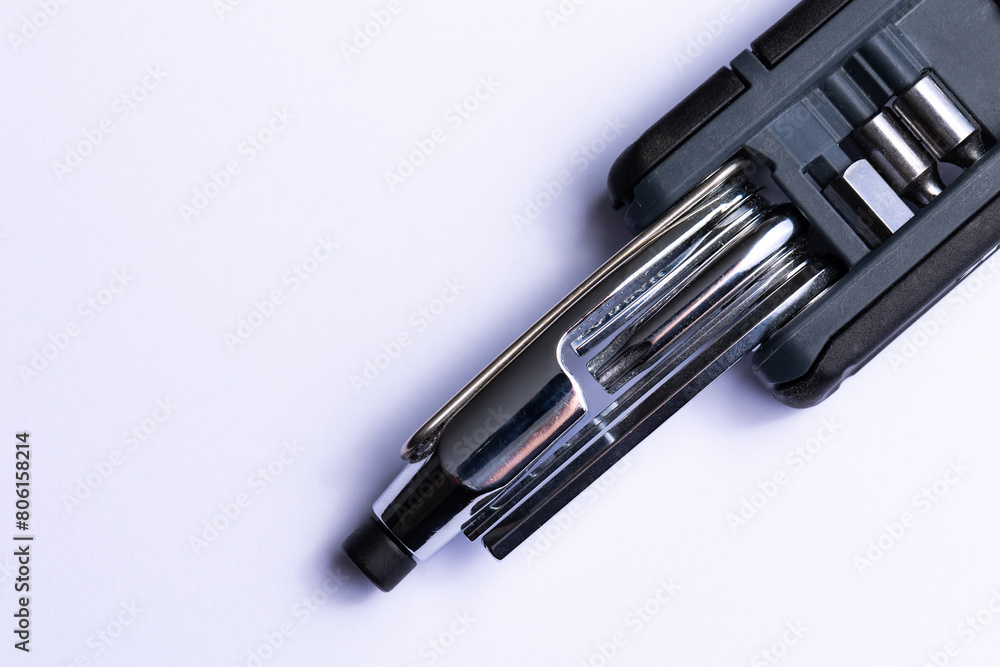 Black bicycle multifunctional multitool unfolded on a white background. Chrome steel tools. Tools for bicycle self-repairing .