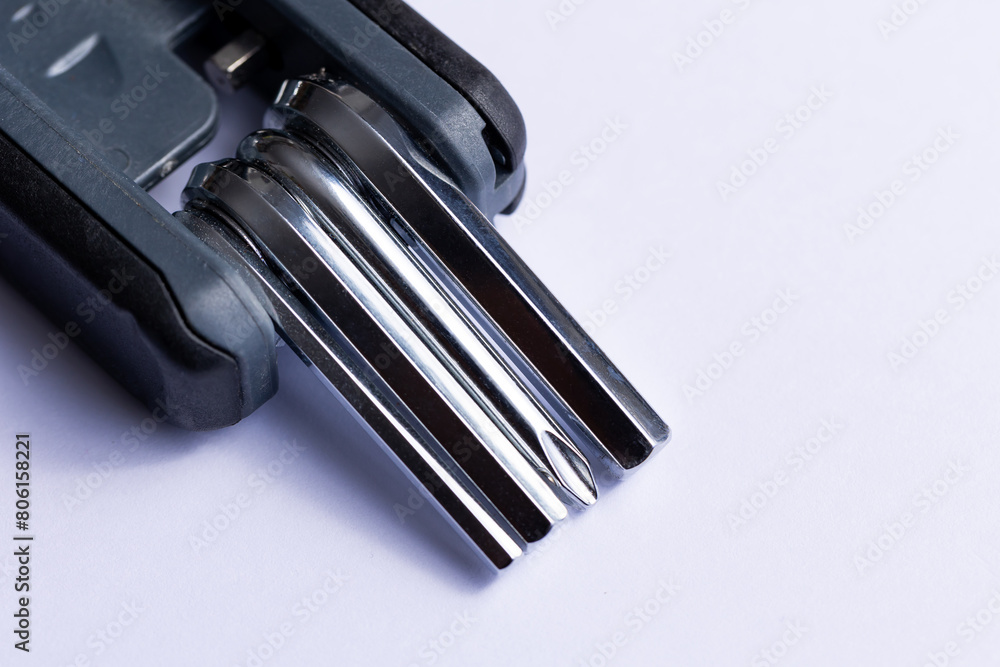 Black bicycle multifunctional multitool unfolded on a white background. Chrome steel tools. Tools for bicycle self-repairing .